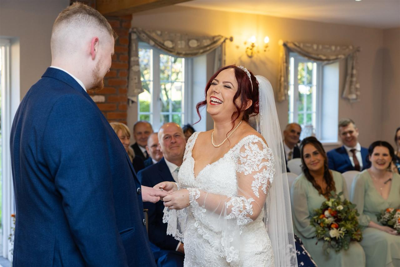 bride and groom exchanging rings at Staffordshire wedding venue